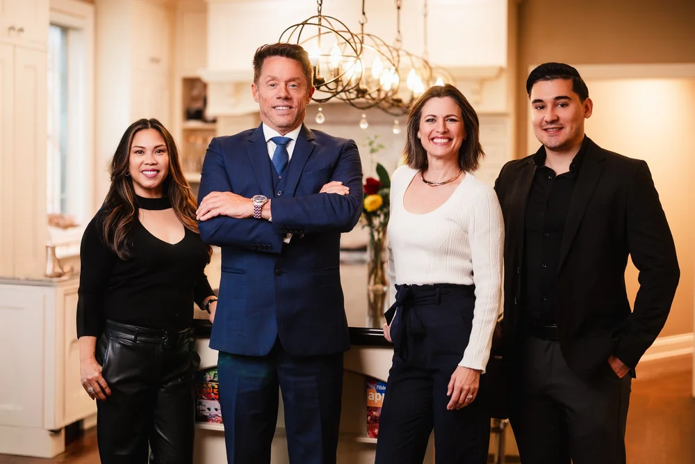 Professional real estate team standing in a bright Naperville home interior, representing Dan Firks Real Estate and its client-focused service.